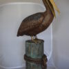 Pelican on a Stump Bronze Statue -  Size: 14"L x 38"W x 58"H.