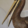 Pelican on a Stump Bronze Statue -  Size: 14"L x 38"W x 58"H.