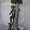 Boy Sitting on a Tree with Mailbox Bronze Statue -  Size: 22"L x 23"W x 49"H.