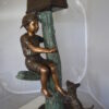 Boy Sitting on a Tree with Mailbox Bronze Statue -  Size: 22"L x 23"W x 49"H.