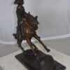 Remington Cowboy on marble Bronze Statue -  Size: 24"L x 9"W x 23"H.