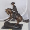 Remington Cowboy on marble Bronze Statue -  Size: 24"L x 9"W x 23"H.