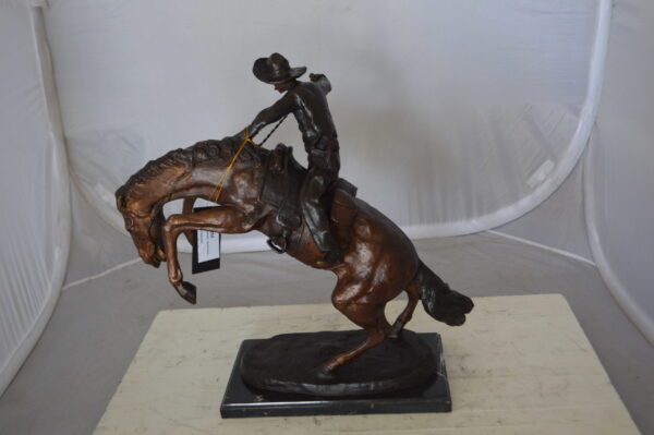 Bronco Buster Bronze Statue by Remington -  Size: 9"L x 24"W x 21"H.