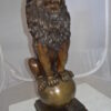 Pair of lions standing on balls, bronze statues -  Size: 14"L x 16"W x 38"H.