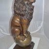 Pair of lions standing on balls, bronze statues -  Size: 14"L x 16"W x 38"H.