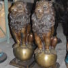 Pair of lions standing on balls, bronze statues -  Size: 14"L x 16"W x 38"H.