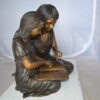 Two Girls Reading a Book Bronze Statue -  Size: 33"L x 21"W x 23"H.