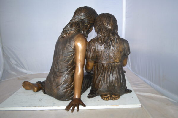 Two Girls Reading a Book Bronze Statue -  Size: 33"L x 21"W x 23"H.