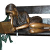 Girl laying on a bench reading a book Bronze Statue -  Size: 27"L x 39"W x 32"H