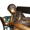 Girl laying on a bench reading a book Bronze Statue -  Size: 27"L x 39"W x 32"H