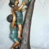 Two Kids Climbing on a Tree Bronze Statue -  Size: 17"L x 17"W x 46"H.