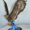 Eagle Catching his Prey Bronze Statue -  Size: 17"L x 20"W x 25"H.