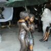 Two Kids Holding an Umbrella - Bronze Statue - Fountain -  90"L x 34"W x 90"H.