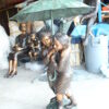 Two Kids Holding an Umbrella - Bronze Statue - Fountain -  90"L x 34"W x 90"H.