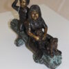 Two kids with dog on log Bronze Statue -  Size: 12"L x 5"W x 8.5"H.