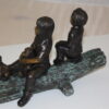 Two kids with dog on log Bronze Statue -  Size: 12"L x 5"W x 8.5"H.