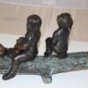 Two kids with dog on log Bronze Statue -  Size: 12"L x 5"W x 8.5"H.