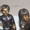 Two kids with dog on log Bronze Statue -  Size: 12"L x 5"W x 8.5"H.