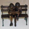 Two kids on bench reading a book - Bronze Statue -  Size: 9"L x 6"W x 8"H.