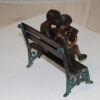 Two kids on bench reading a book - Bronze Statue -  Size: 9"L x 6"W x 8"H.