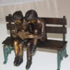 Two kids on bench reading a book - Bronze Statue -  Size: 9"L x 6"W x 8"H.