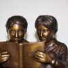 Two kids on bench reading a book - Bronze Statue -  Size: 9"L x 6"W x 8"H.