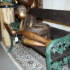 Girl laying on a bench reading a book Bronze Statue -  Size: 27"L x 39"W x 32"H