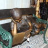 Girl laying on a bench reading a book Bronze Statue -  Size: 27"L x 39"W x 32"H