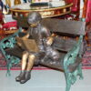 Girl sitting with her dog  on a bench,  reading Bronze Statue - 27" x 39" x 32"H