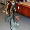 Kid with dog walking on a log Bronze Statue -  Size: 57"L x 18"W x 41"H.