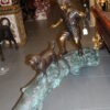 Kid with dog walking on a log Bronze Statue -  Size: 57"L x 18"W x 41"H.