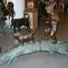 Kid with dog walking on a log Bronze Statue -  Size: 57"L x 18"W x 41"H.