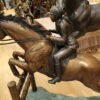 Jockey and Horse Jump a Fence Bronze Statue -  Size: 60"L x 30"W x 51"H.