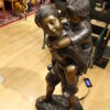 Boy Giving Girl Piggyback Ride Bronze Statue -  Size: 23"L x 16"W x 46"H.