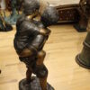 Boy Giving Girl Piggyback Ride Bronze Statue -  Size: 23"L x 16"W x 46"H.