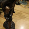 Boy Giving Girl Piggyback Ride Bronze Statue -  Size: 23"L x 16"W x 46"H.