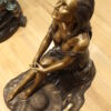 Lady on Stone Bronze Statue -  Size: 33"L x 23"W x 34"H.