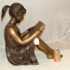 Girl Sitting and Reading a Book Bronze Statue -  Size: 23"L x 15"W x 24"H.