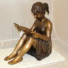 Girl Sitting and Reading a Book Bronze Statue -  Size: 23"L x 15"W x 24"H.