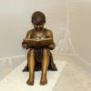 Girl Sitting and Reading a Book Bronze Statue -  Size: 23"L x 15"W x 24"H.