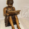 Girl Sitting and Reading a Book Bronze Statue -  Size: 23"L x 15"W x 24"H.