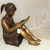 Girl Sitting and Reading a Book Bronze Statue -  Size: 23"L x 15"W x 24"H.