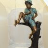 Boy Sitting on a Tree and Fishing Bronze Statue -  Size: 36"L x 21"W x 37"H.