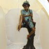 Boy Sitting on a Tree and Fishing Bronze Statue -  Size: 36"L x 21"W x 37"H.