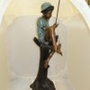 Boy Sitting on a Tree and Fishing Bronze Statue -  Size: 36"L x 21"W x 37"H.