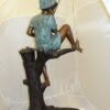 Boy Sitting on a Tree and Fishing Bronze Statue -  Size: 36"L x 21"W x 37"H.