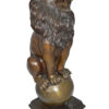 Pair of lions standing on balls, bronze statues -  Size: 14"L x 16"W x 38"H.