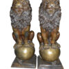 Pair of lions standing on balls, bronze statues -  Size: 14"L x 16"W x 38"H.