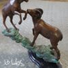 Two Rams on a rock Bronze Statue -  Size: 15"L x 8"W x 16"H.