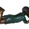 boy laying reading book bronze Statue -  Size: 24"L x 10"W x 11"H.